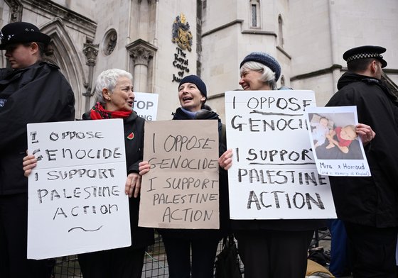Demonstrators gather outside the High Court during a ruling on whether the government's ban of Palestine Action was unlawful on February 13, 2026 in London, United Kingdom.