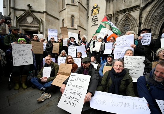 Demonstrators gather outside the High Court during a ruling on whether the government's ban of Palestine Action was unlawful on February 13, 2026 in London, United Kingdom.