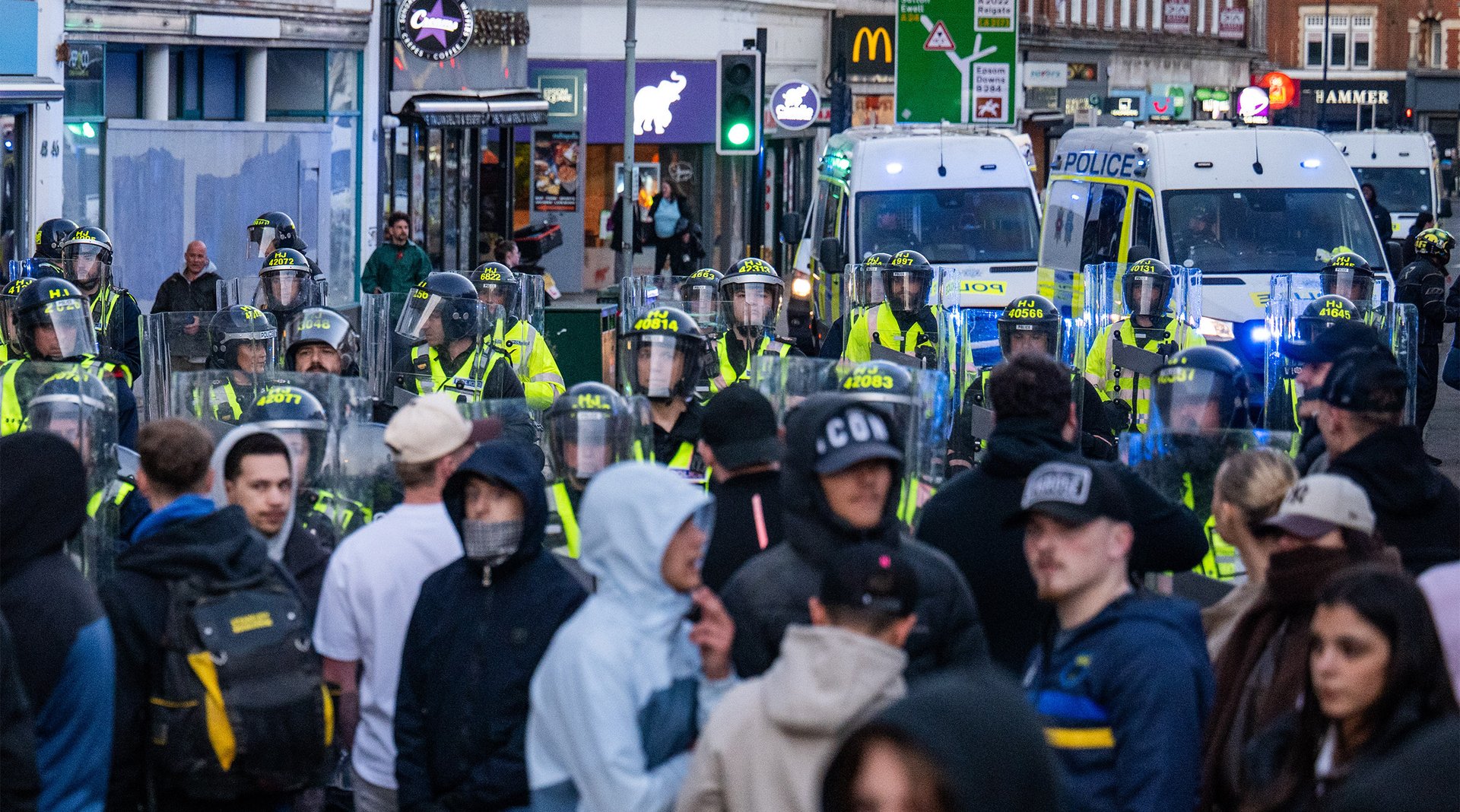 Riot police confront far-right protesters in Epsom