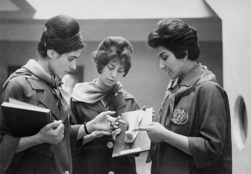 Two Afghan medicine students (Left & Center) listening to their Professor at the Faculty of Medicine in Kabul, as they examine a plaster showing a part of a human body - January 1962