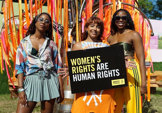 Women holding an Amnesty placard that reads Women's Rights Are Human Rights