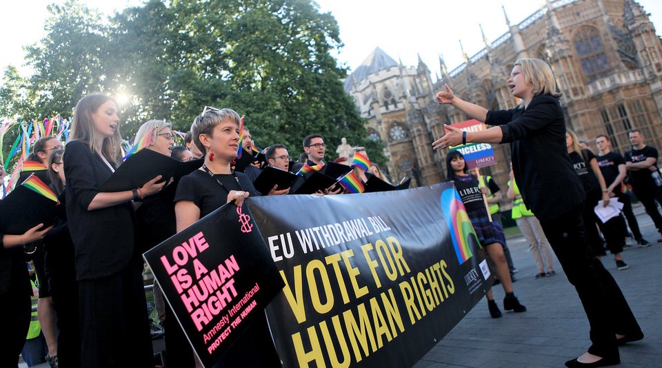 Group of activists holding an Amnesty banner that reads "Vote for Human Rights"