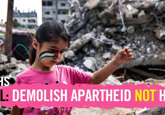 Child with a Palestinian flag painted on their face in front of rubbles of broken homes