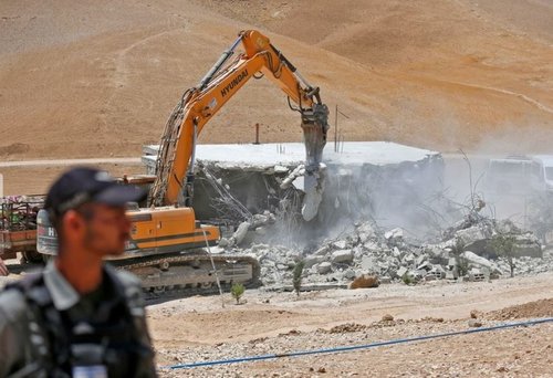 Israeli forces using a Hyundai bulldozer to demolish a Palestinian house in the Umm Qasas area of Masafer Yatta on 25 July 2022