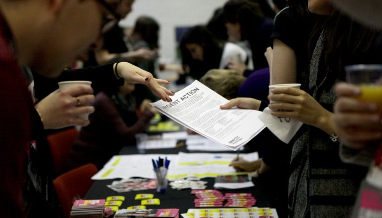 People holding and discussing documents about human rights.