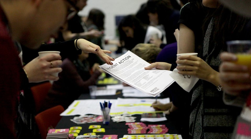 People holding and discussing documents about human rights.