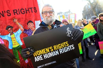 Protestor holding a "women's rights are human rights" placard