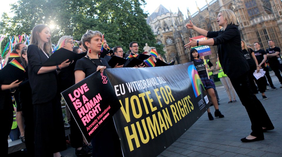 Amnesty activist holding a banner that reads Vite For Human Rights