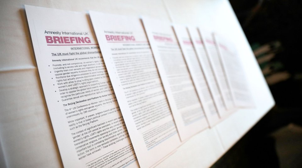 Amnesty International Briefing papers laid out on a table