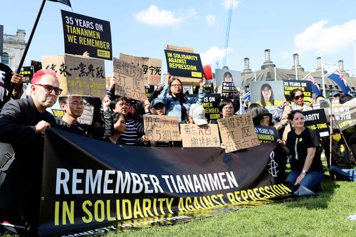 A number of protestors holding remembrance signs for 35 years since the Tiananmen square massacre.