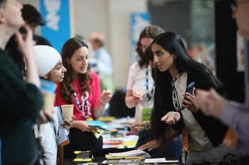 Amnesty activists conversing around a table at Amnesty Amplify