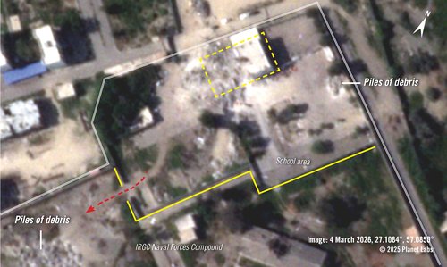 A closer look at the school in imagery from 4 March 2026 shows the western part of the school building is missing and a large pile of rubble is visible. A new opening in the wall and path from the IRGC compound - highlighted with a red dotted arrow - lead