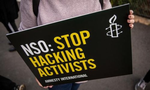 An Amnesty International placard that says 'NSO: Stop Hacking Activists'