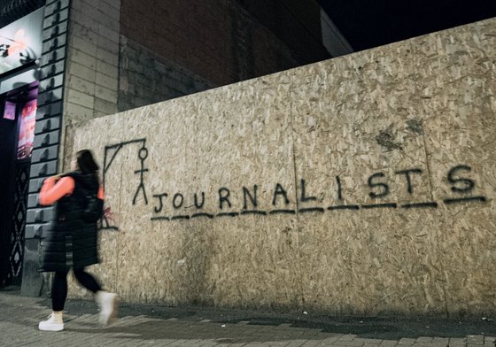 Graffiti on a wall in the style of hangman game spells out 'Journalists'