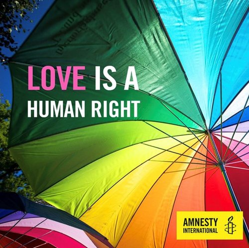 A rainbow umbrella embellished with the words 'love is a human right'