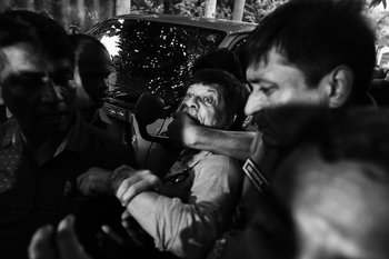 Shahidul Alam being taken away by police.