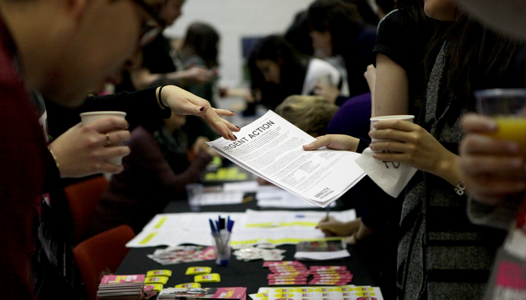 Urgent action leaflet handed by an activist to a supporter