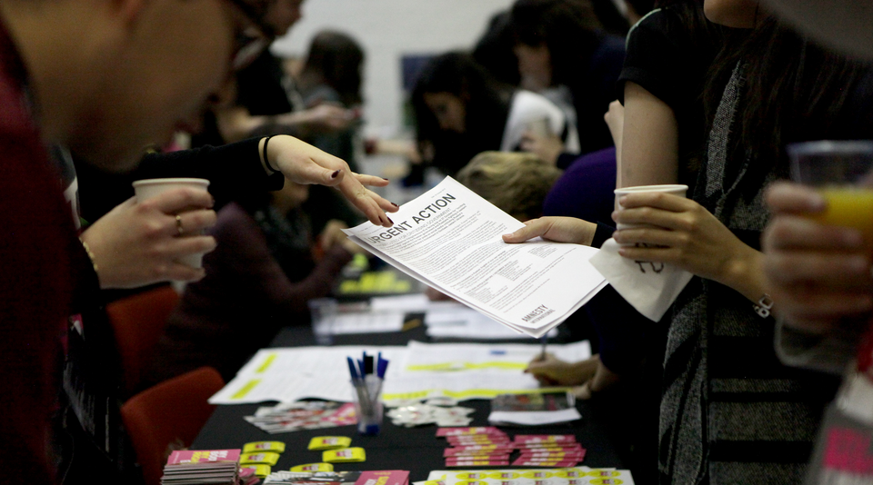 Urgent action leaflet handed by an activist to a supporter