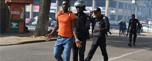A man being arrested in Ivory Coast