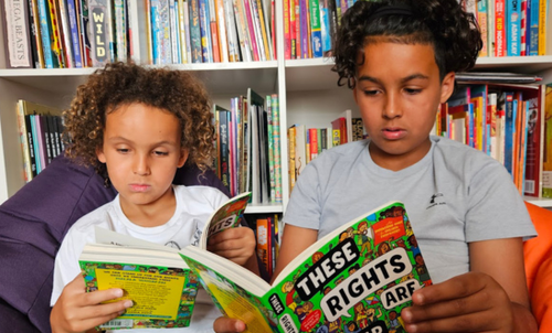 Photo of two children reading