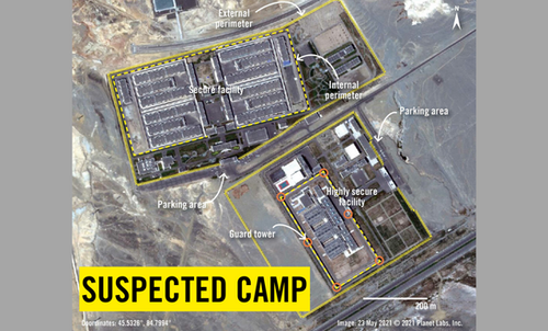 A satellite image shows a suspected camp where one can see security structures, guard towers. It looks like a remote location