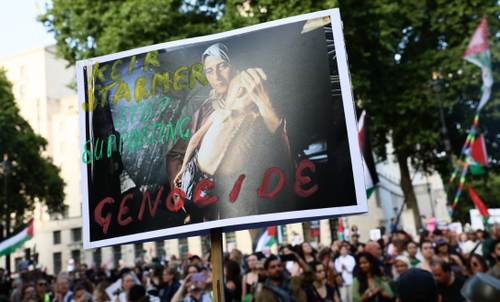 A person holding placard at a protest in London