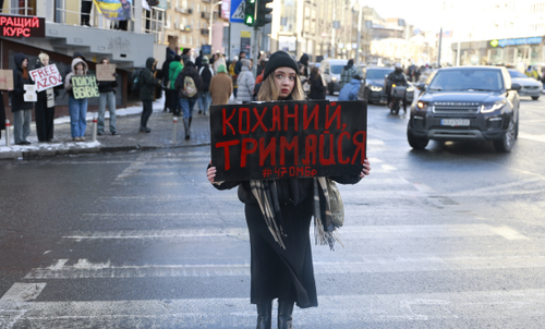 Alina Potapova holds a placard at a demonstration in Kyiv. The sign reads “Hold on, my love”. Her fiancee went missing in July 2023, and was later confirmed to be in Russian captivity. Alina has not received any letters from him.