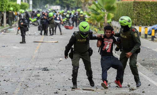 Colombian police officers arrest a demonstrator during a protest against the government in Cali, Colombia, on 4 June, 2021