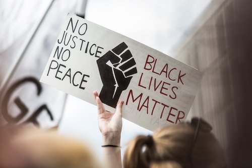 Protester holds sign, no justice, no peace, Black Lives Matter