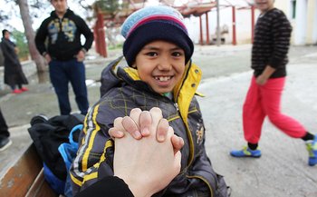 Child holding someone's hand