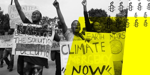 Three protesters holding a sign that says 'Climate Emergency Now'