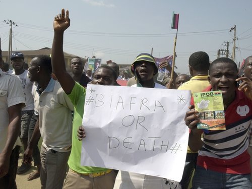 Pro-Biafra supporters hold a placard as they march through the streets of Aba, s
