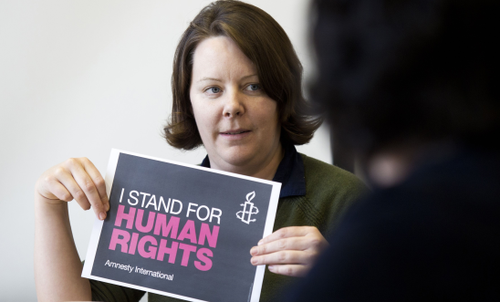 Woman holding a banner that reads 'I stand for human rights'