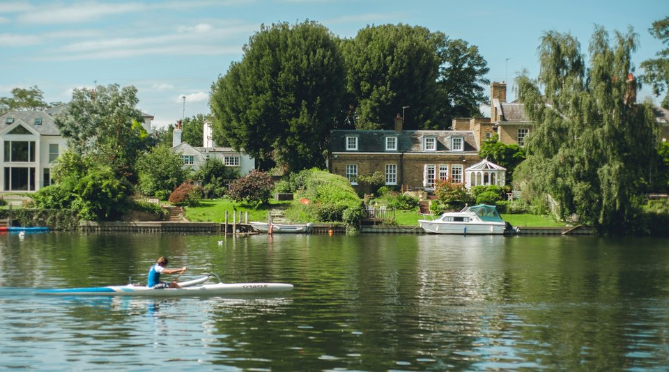 Rower training on the river Thames in summer