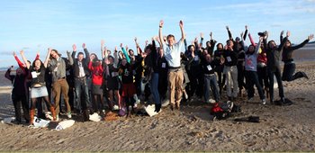 An image of a group of people celebrating, some people are jumping in the air