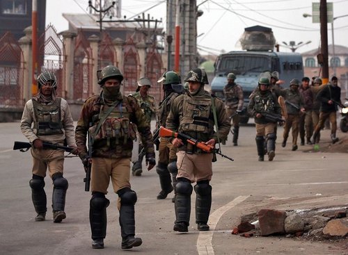 Photo of armed soldiers on a road
