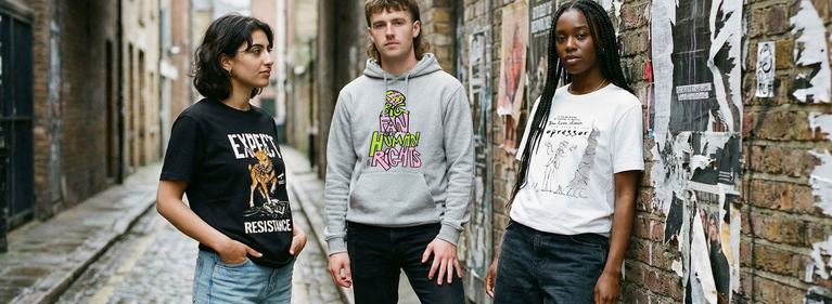 Three people wearing versions t-shirts from the new Amnesty collection