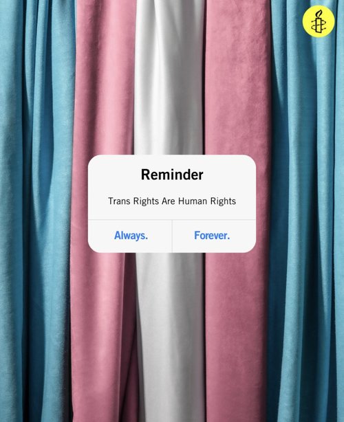 Iphone reminder message reads: Reminder, trans rights are human rights. always. forever. In the background are the colours of the trans flag and a yellow Amnmesty International logo in the top right hand corner.