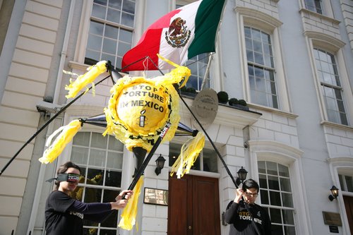 two_activists_and_pinata_and_flag_0.jpg