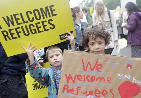 Children holding placards in support of refugees