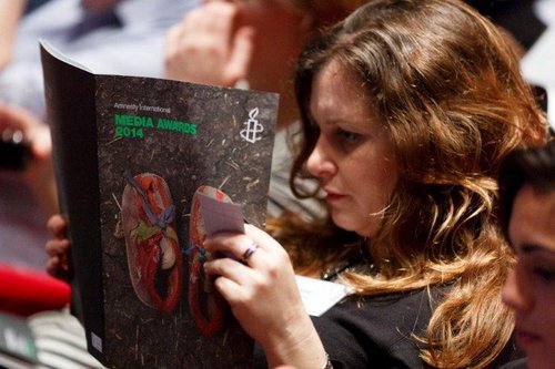 Woman reading brochure - Media Awards