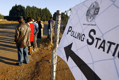 Picture of a queue of people outside of a polling station.